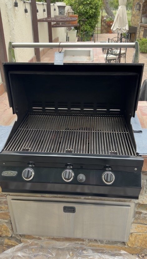 Built-in outdoor grill with the hood open after a Grimy Grills cleaning